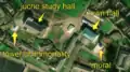 3/7 Another city centre with a mural (artwork_type=mural and tourism=artwork), recognisable because it has the shape of a wall that leaves a shadow on the ground, with no building in the immediate vicinity, a juche study hall (amenity=community_centre), with its specific shape, the Tower of Immortality (historic=memorial), with its shadow on the ground, and the Town Hall (amenity=townhall) (Maxar satellite imagery).