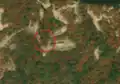 1/6 Communication tower (man_made=tower and tower:type=communication), with an antenna and a small building, on top of a mountain (Maxar satellite imagery).