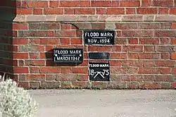 flood_mark=plaqueFlood marks on the wall of a lock keeper's cottage