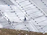 Capped landfill without natural covering