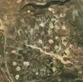 5/8 Disorganized cemetery (landuse=cemetery), without structure on hilly land (Maxar satellite imagery).