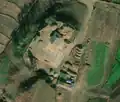 2/6 Farmyard (landuse=farmyard) surrounded by a fence with hay piles, connected to the road (Maxar satellite imagery).