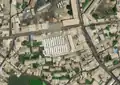 3/7 Public market (amenity=marketplace) with twenty-one stalls, surrounded by a perimeter wall (satellite imagery Maxar).