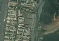 5/7 Public market (amenity=marketplace) with many stalls, surrounded by a perimeter wall (Maxar satellite imagery).