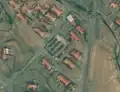 7/7 Public market (amenity=marketplace) with three spaced stalls, surrounded by a perimeter wall (Maxar satellite imagery).