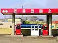 1/3 Gas station (amenity=fuel), whose flat red roof rests on four poles.