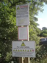 A shooting range warning sign in the UK(boundary=hazard + hazard=shooting_range)