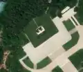 4/4 The same statues of Kim Il-sung and Kim Jong-Il (artwork_type=statue and tourism=artwork) on a white square plinth with satellite imagery (satellite imagery Maxar).