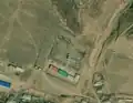 2/4 Substation (power=substation) in the middle of a city which can be recognized with many small features on a flat surface (Maxar satellite imagery).