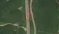 5/6 Stone pillars (barrier=tank_trap) along the road in the valley (Maxar satellite imagery).