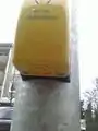 This photo shows the button to activate the vibration function of a pedestrian traffic signal, located at the bottom of the device.