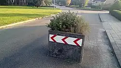 Some planters placed on a road are part of traffic_calming=choker or traffic_calming=chicane. Such barrier=planter should be likely combined with proper traffic_calming=* value and vehicle=yes to mark that it is not completely blocking passage. Or maybe tagged as man_made=planter + traffic_calming=choker?